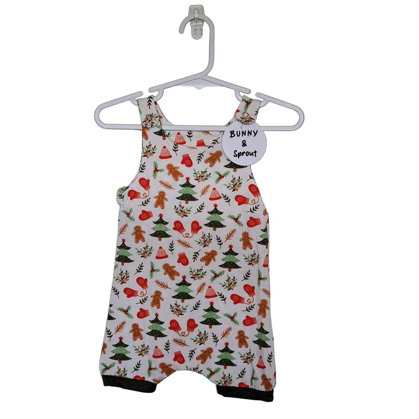 A Christmas-themed romper with a pattern that includes red and green Christmas trees, white snowflakes, and the text 'Bunny Sprout'.