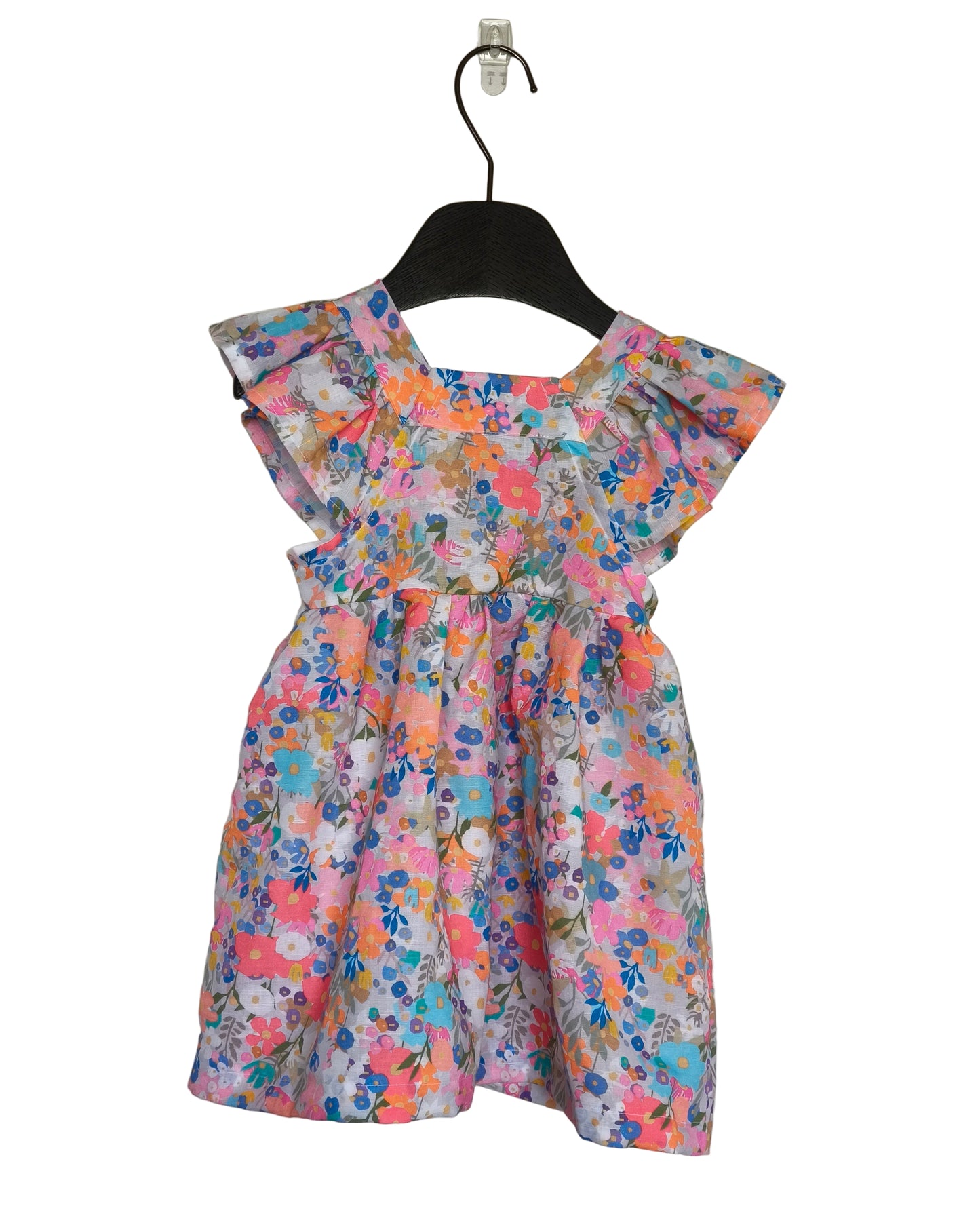 A mid-length, floral patterned ruffle dress for children, displayed on a hanger against a neutral background.