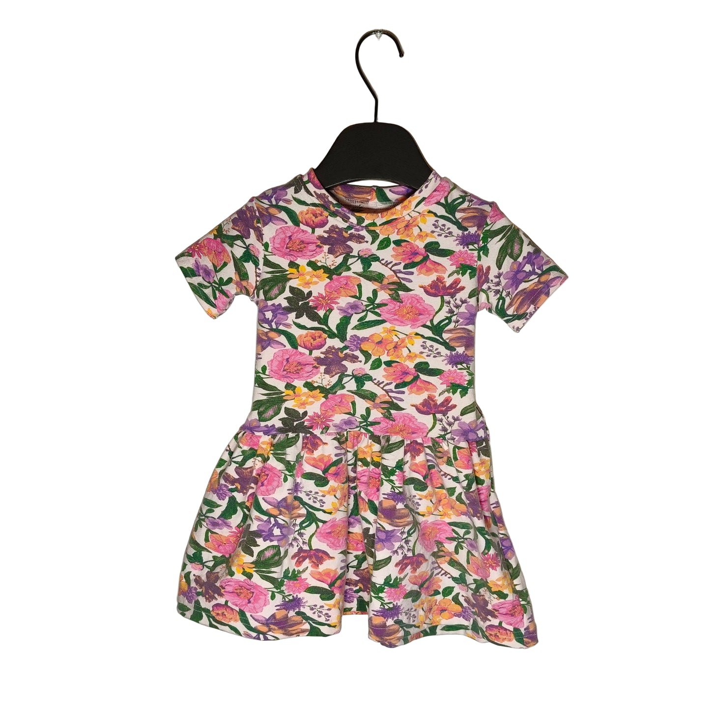 A mid-length floral print t-shirt dress displayed on a hanger against a white background.