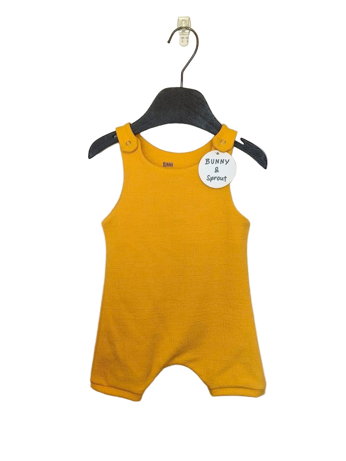 Yellow baby romper on a hanger with a visible brand tag against a plain background