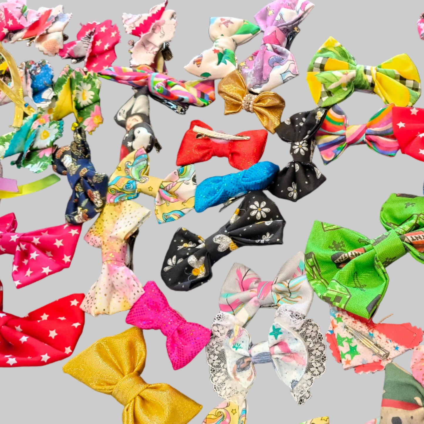 A collection of various hair bows in different colors and patterns displayed on a table.