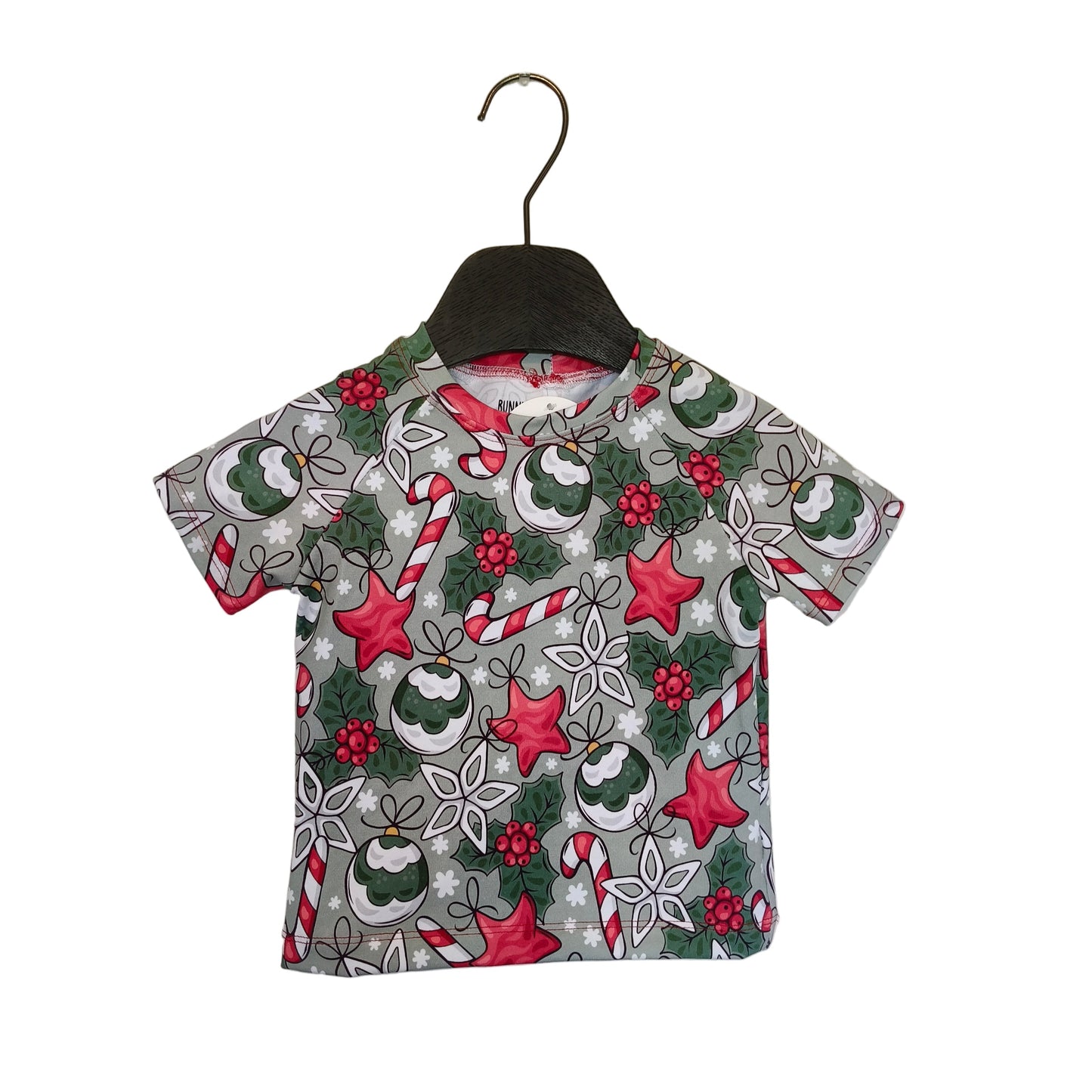 Christmas-themed shirt on a hanger against a plain background