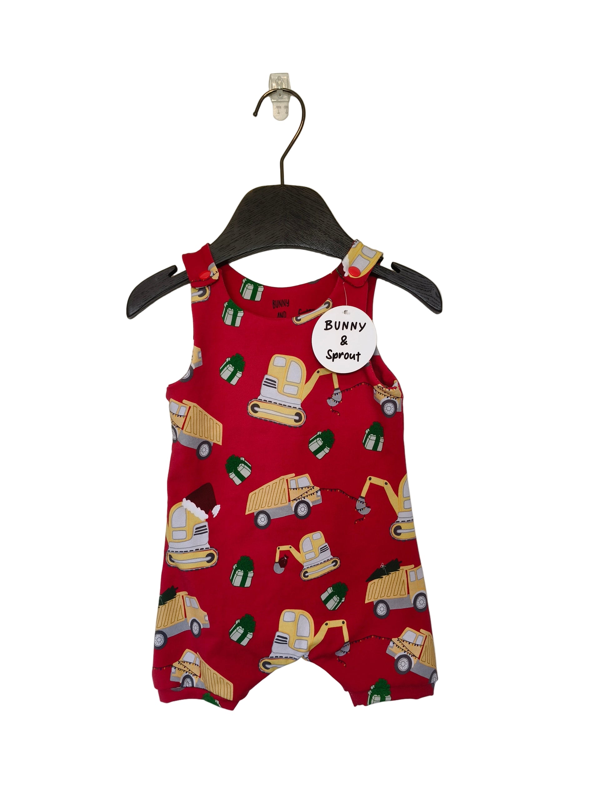 Red romper with construction vehicle pattern on a hanger against a white background