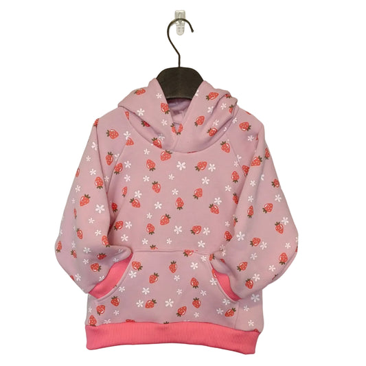 Pink hoodie with strawberry pattern on a hanger against a plain background