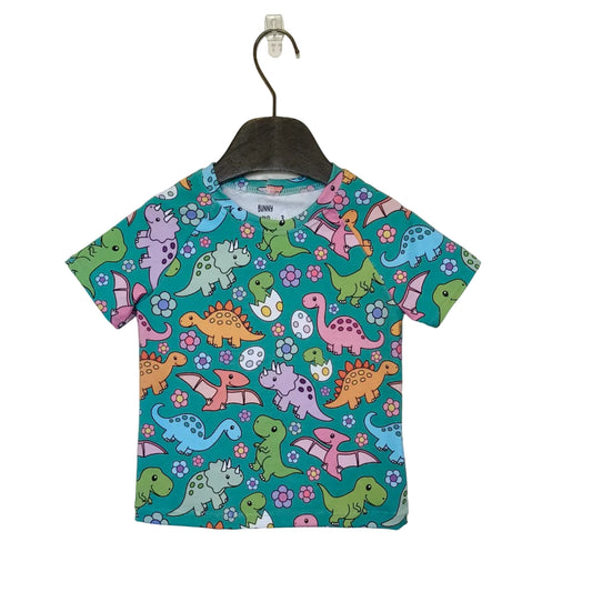 Children's t-shirt with colorful dinosaur pattern on a hanger against a plain background
