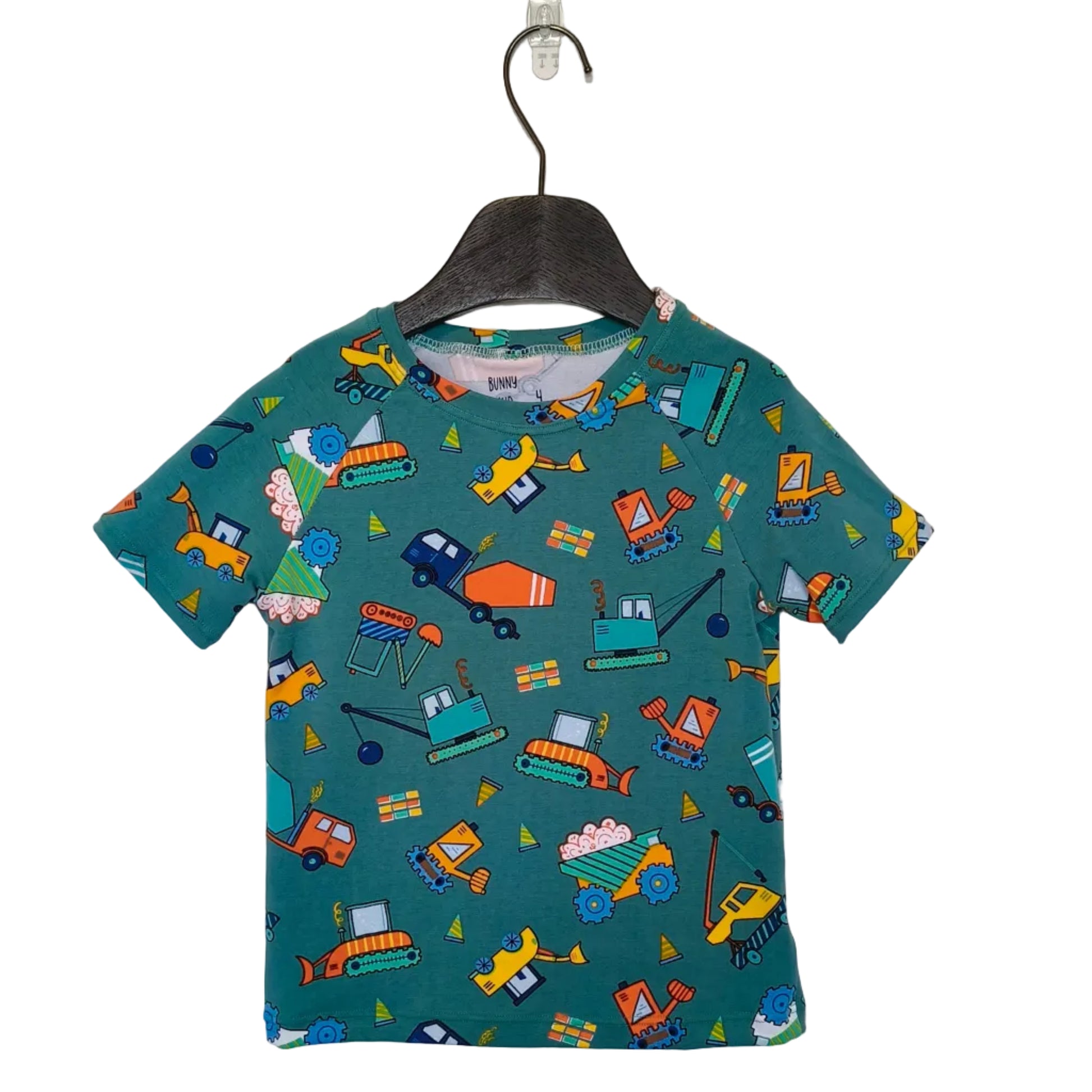 Children's t-shirt with vehicle pattern on a hanger against a plain background