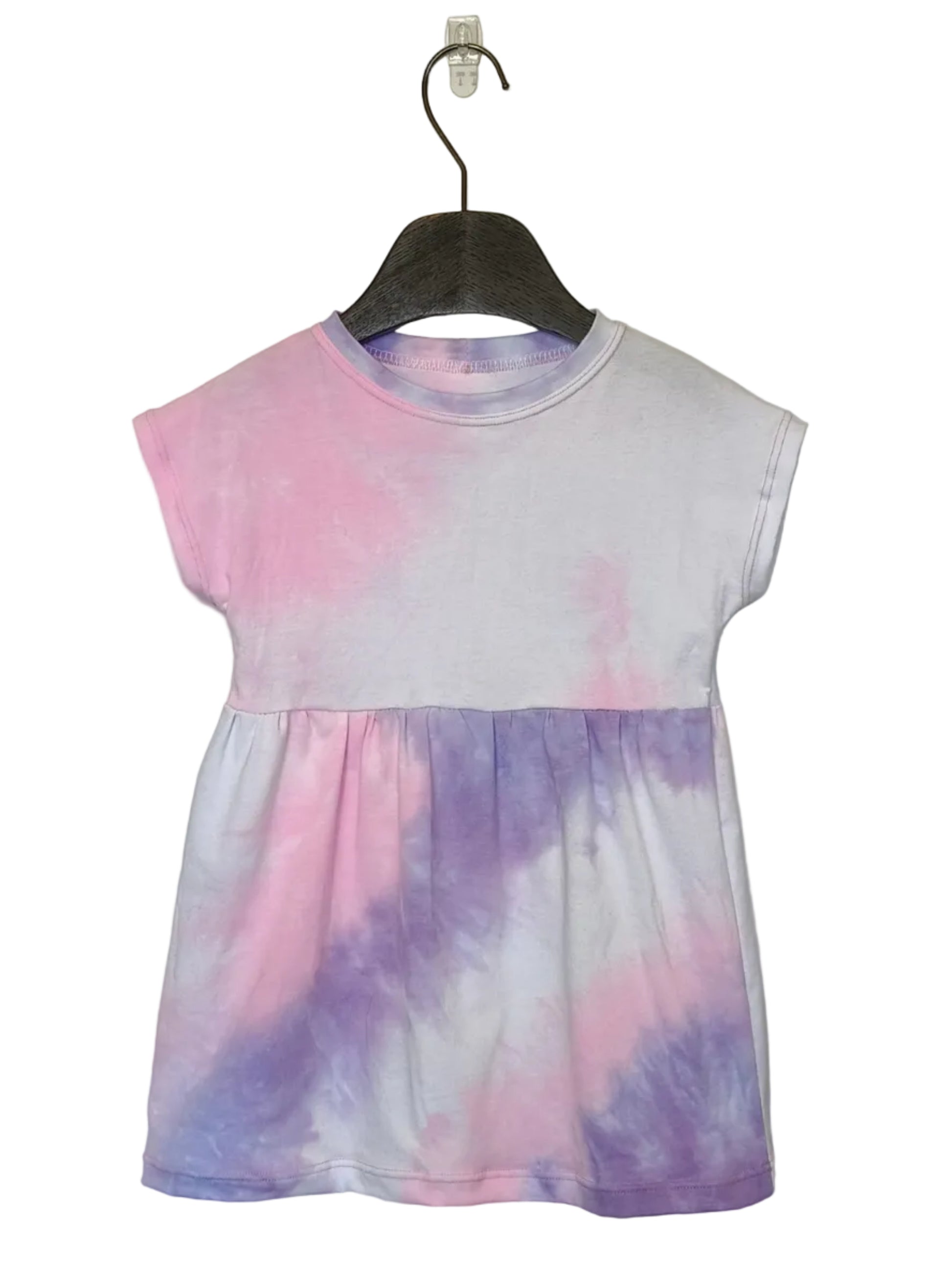 Tie-dye dress on a hanger against a plain background