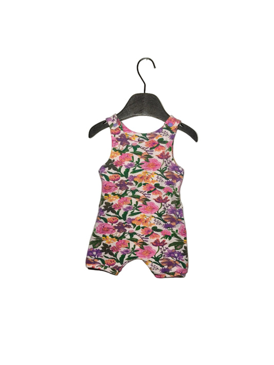 Floral-patterned romper on a hanger against a white background